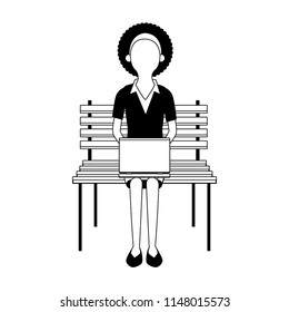 Businesswoman seated on chair using laptop faceless in black and white