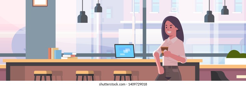 businesswoman sitting on chair at bar counter with laptop coffee break concept business woman drinking cappuccino modern cafe interior flat portrait horizontal