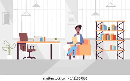 businesswoman sitting at workplace holding paper documents african american business woman preparing report working process concept modern office interior flat horizontal