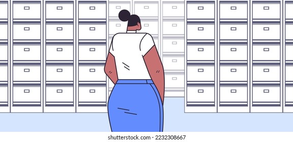 businesswoman standing back to camera rear view of elegant business woman in file cabinet office interior