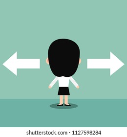 Businesswoman standing in front of two arrows.