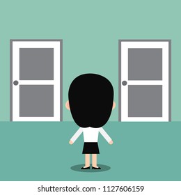Businesswoman standing in front of two door.s