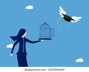 Businesswoman unleashes graduation cap flying out of the cage. Liberation of learning achievements and freedom