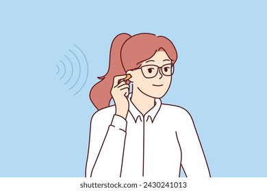 Businesswoman uses earplugs to get rid of noise that reduces concentration and productivity. Girl holds wireless headphones for listening to music or hearing aid that allows to restore hearing.