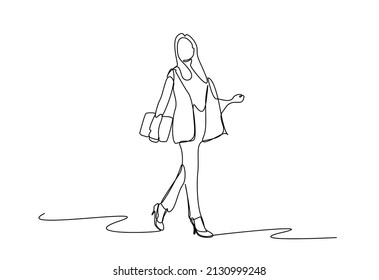 businesswoman walking cheerfully with files in her hands in the office