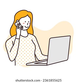 Businesswoman working in front of a laptop while calling