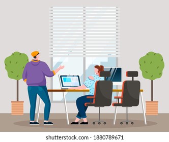 Businesswomen dressed in casual clothes sitting at the table with computer, standing in room and talking. Office meeting and consideration of working affairs. Office workers women in workspace