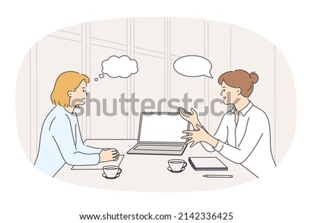 Businesswomen sit at desk talk brainstorm at office meeting. Female colleagues or business partners have negotiations or briefing. Empty copy space in speech bubble. Vector illustration. 