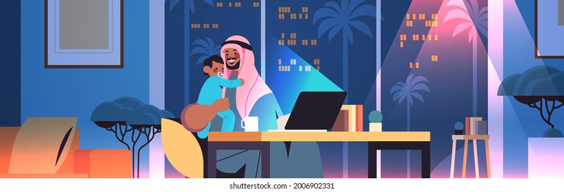 busy arab father freelancer with little son looking in laptop screen freelance fatherhood concept