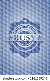 Busy blue emblem with geometric pattern background.
