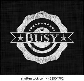 Busy chalk emblem written on a blackboard