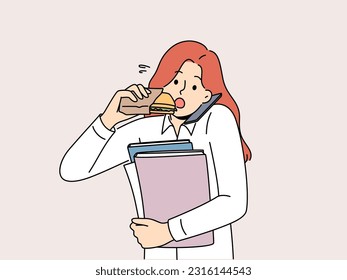 Busy multitasking woman answers phone biting on sandwich to save time at lunch. Young businesswoman with folders in hands eats and works in multitasking mode, wishing to succeed in career