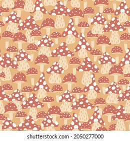 Busy mushrooms pattern repeat creating a texture in red, orange and beige. Seamless background print. Vector illustration. Fall kids projects, fall designs and home decor projects. Surface pattern