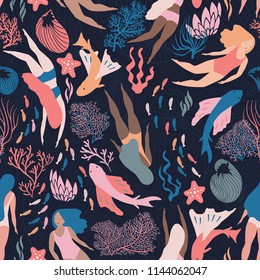 Busy ocean life with fish and like mermaid girls swimming among corals and sea weed. Dark bacground. Vector seamless pattern.