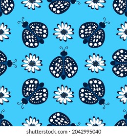 Butterflies and daisies on a blue background.Abstract vector pattern for textiles, fabric, background, packaging paper, wallpaper.