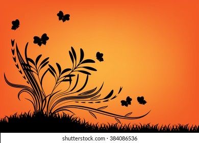 butterflies and flora in the garden during sunset and orange sky.