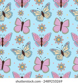 Butterflies and flowers seamless pattern on blue background.