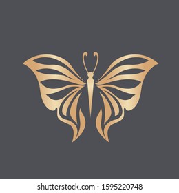 Butterfly logo.Beautiful, decorative icon with ornamental wings.Creative flying shape in golden metallic color isolated on dark background.Beauty, spa, fashion, luxury boutique, elegant art style.