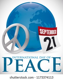 Button with Earth planet silhouette inside of it, silver peace symbol and loose-leaf calendar with reminder date for International Day of Peace: 21st September.