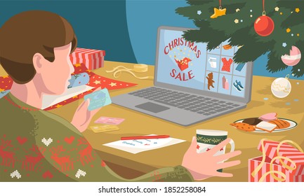 Buying christmas andnew year gifts online - online shopping concept Man make order on laptop with credit card prepare to christmas, among gift boxes and packages. Winter holidays sales