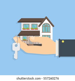 Buying Or Selling A House. Hand Holding Keys And A Small House. Concept Of Real Estate. Big Villa.