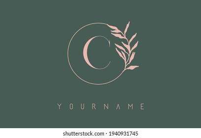 C Letter logo design with dust pink circle and leaves on a green background. Initial Letter C Vector Illustration with Botanical elements. Nature vector template design concept with C letter.