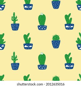 Cacti in blue pots on a sandy background.