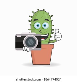 Cactus mascot character holding camera. vector illustration