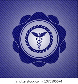 Caduceus medical icon with denim texture