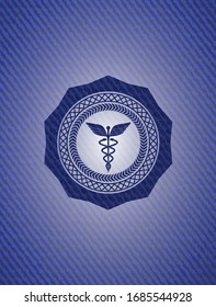 Caduceus medical icon with denim texture