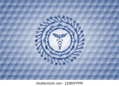 Caduceus medical icon inside blue emblem or badge with geometric pattern background.