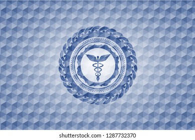 Caduceus medical icon inside blue emblem or badge with abstract geometric polygonal pattern background.