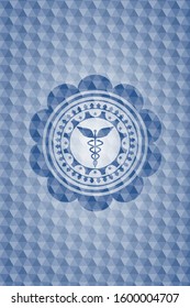 Caduceus medical icon inside blue emblem or badge with geometric pattern background.