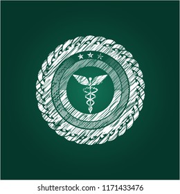 Caduceus medical icon inside chalkboard emblem