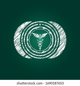 Caduceus medical icon inside chalkboard emblem on black board