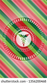 Caduceus medical icon inside christmas colors badge.