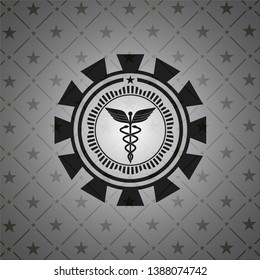 Caduceus medical icon inside dark emblem