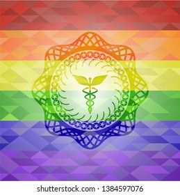 Caduceus medical icon inside emblem on mosaic background with the colors of the LGBT flag