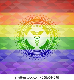 Caduceus medical icon inside emblem on mosaic background with the colors of the LGBT flag