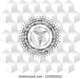 Caduceus medical icon inside grey emblem with geometric cube white background