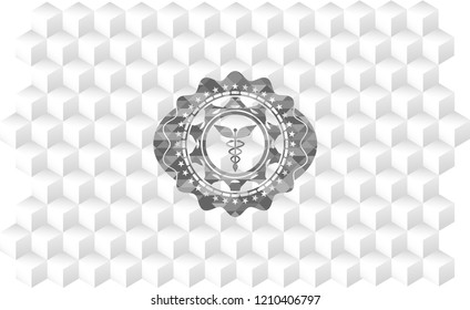 Caduceus medical icon inside grey emblem with geometric cube white background