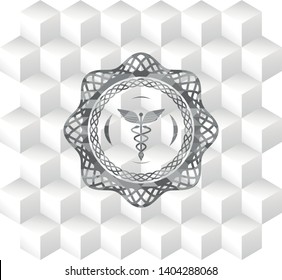 Caduceus medical icon inside grey emblem with cube white background