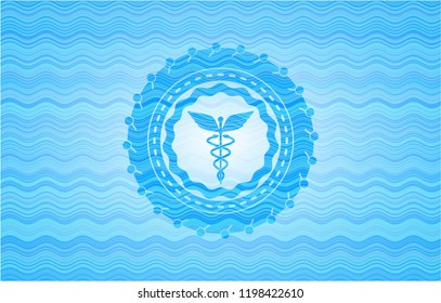 Caduceus medical icon inside light blue water emblem.