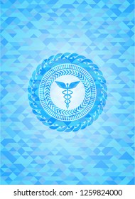 Caduceus medical icon inside realistic sky blue mosaic emblem