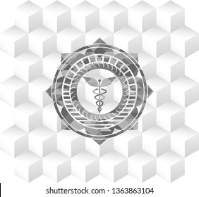 Caduceus medical icon inside retro style grey emblem with geometric cube white background
