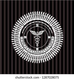 Caduceus medical icon inside silver emblem or badge