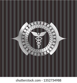 Caduceus medical icon inside silver badge