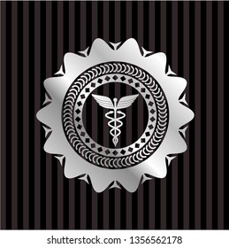 Caduceus medical icon inside silver emblem