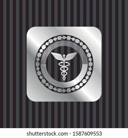 Caduceus medical icon inside silver emblem or badge