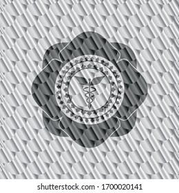 Caduceus medical icon inside silver emblem. Scales pattern. Vector Illustration. Detailed.